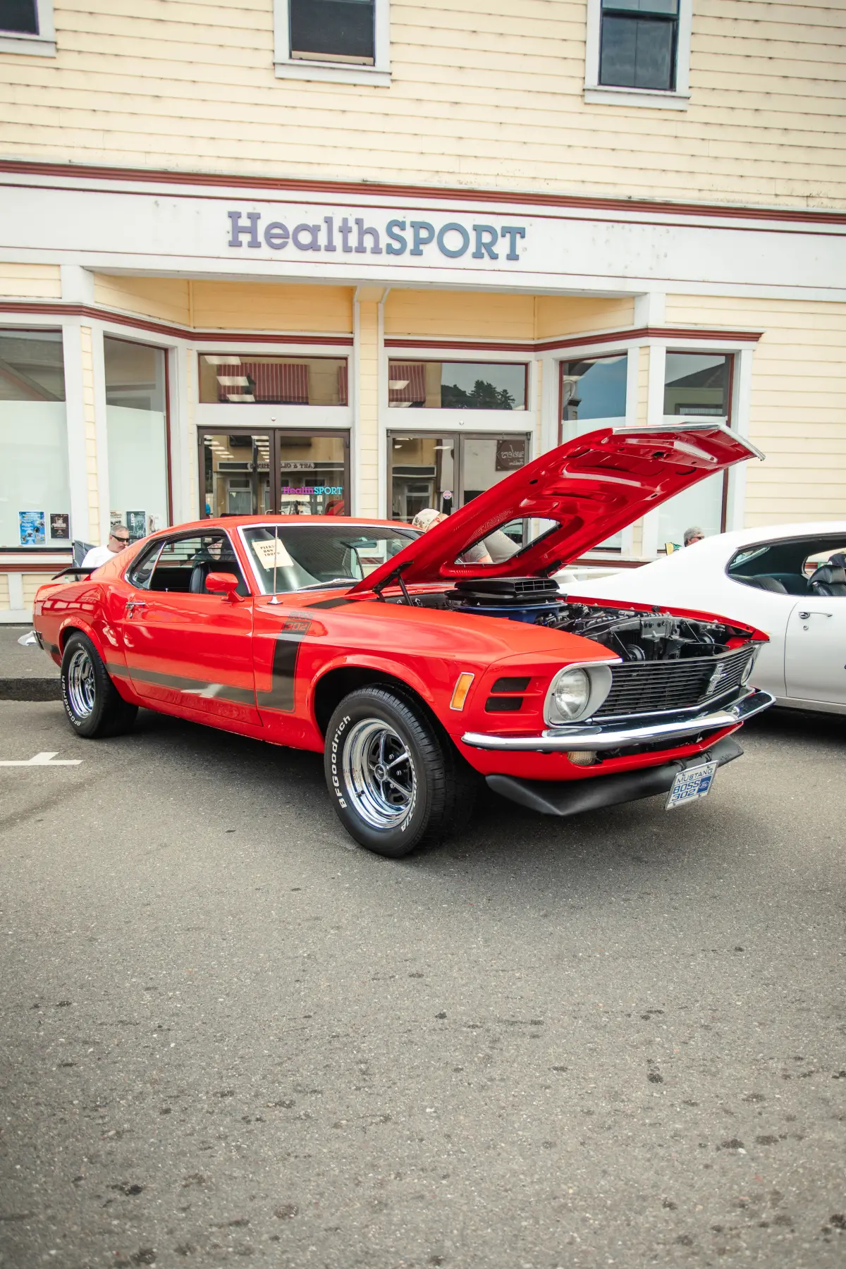 Red Ford Mustang Boss in the Kreations Auto Body showroom