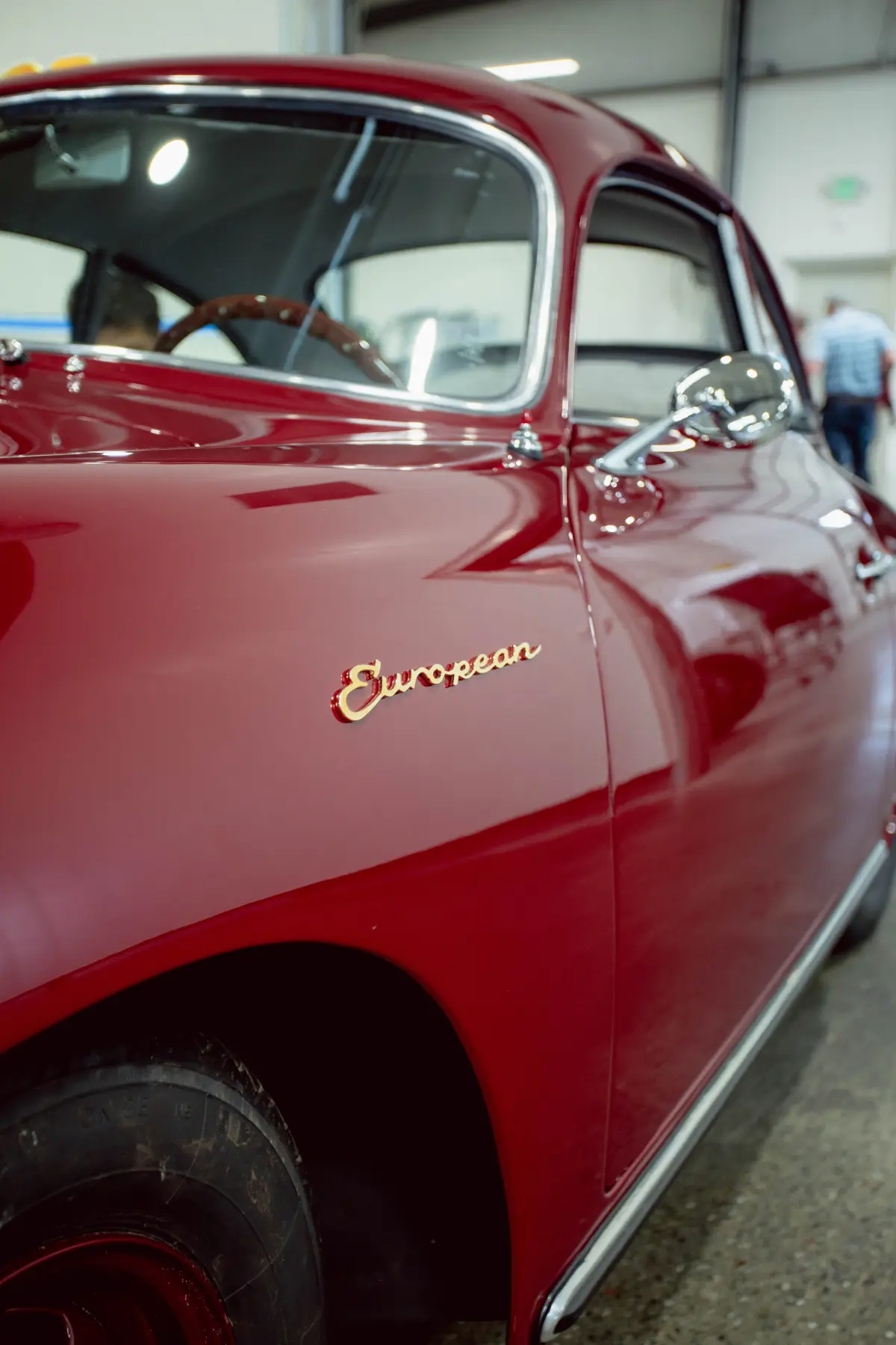 Chrome script on deep red paint of a restored classic at Kreations Auto Body